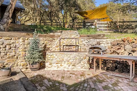 The shared patio has a oak pit BBQ, Traegar, and an OONI pizza oven. Fire wood is provided.