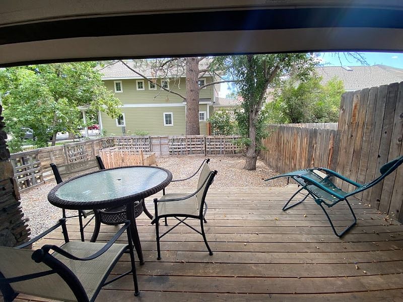 View of deck off of kitchen and fenced yard.