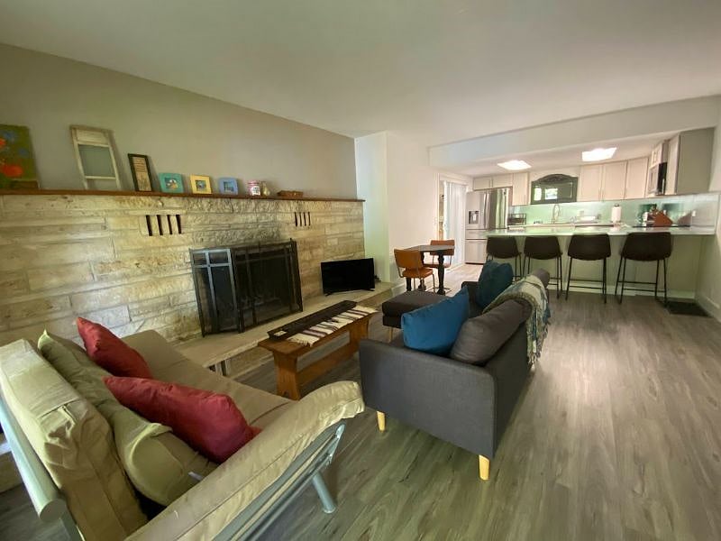 View of Living Room area, open to kitchen with bar.