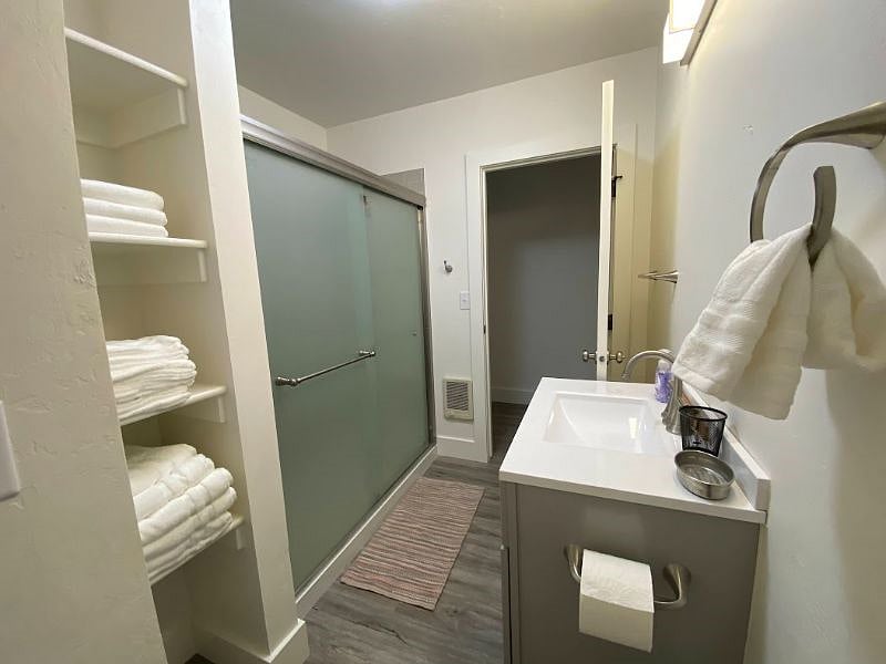 Bathroom with new sink, shower, toilet and flooring.
