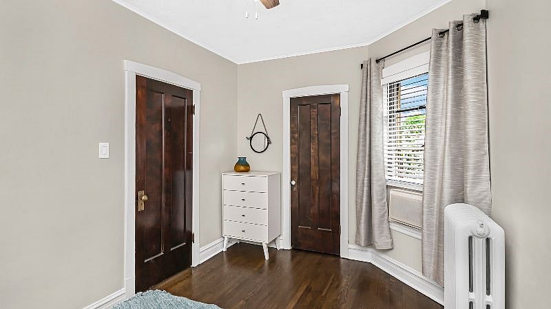 Bedroom 1 offers ample closet space, hangers, a full dresser, remote operated AC, and black-out curtains.