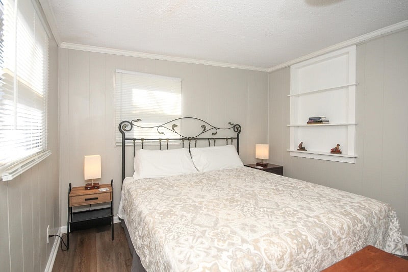 Second bedroom with cozy king bed and bedside lamps

