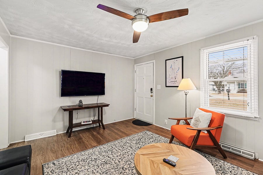 Wall-mounted TV + cozy seating for a relaxed night in