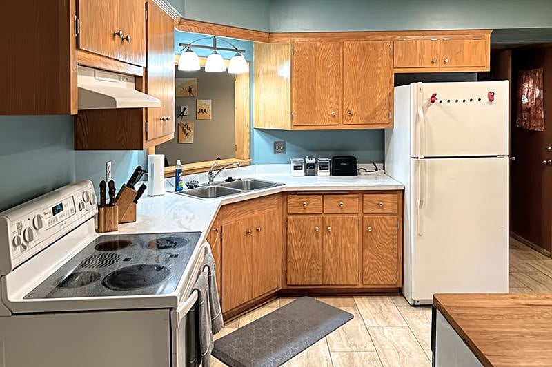 Generous kitchen with original wood cabinets