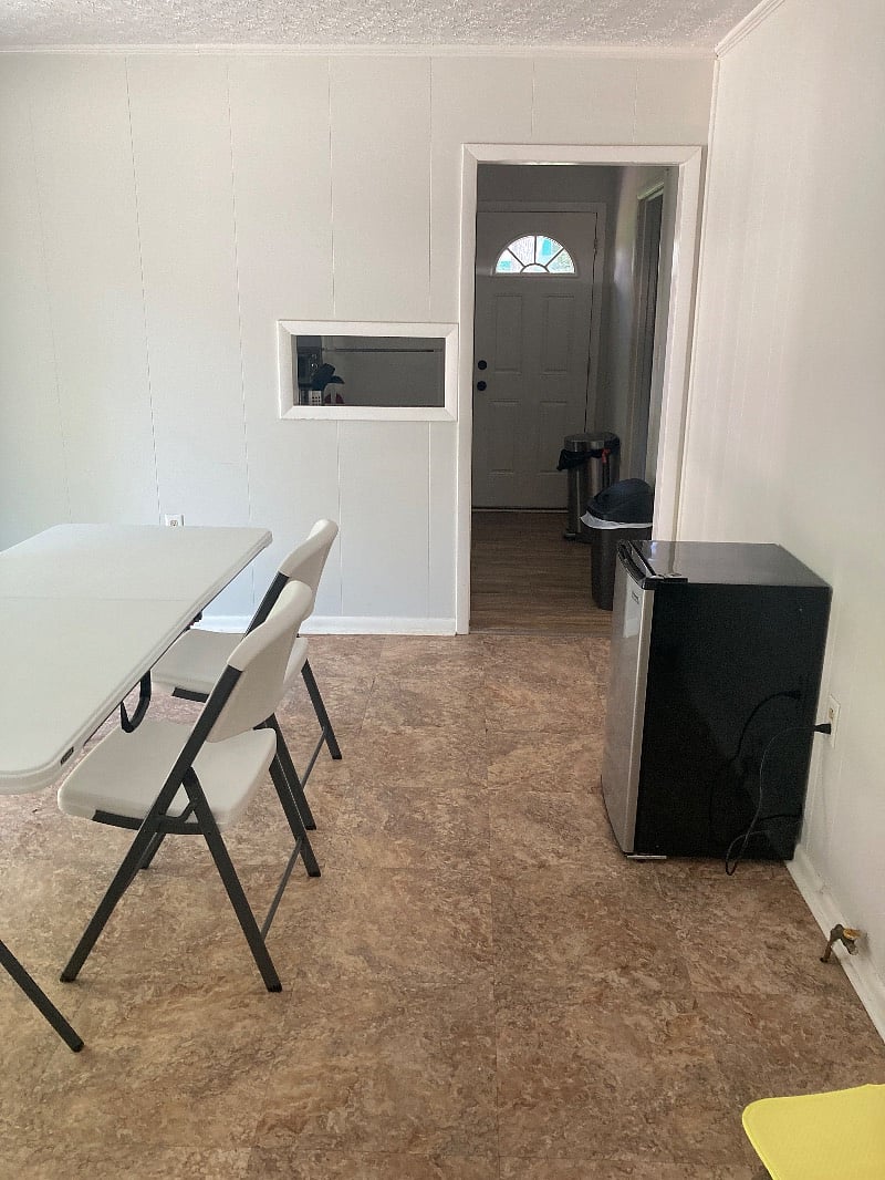 Work area between kitchen and hallway to bedrooms. Has sliding glass door facing small patio and parking.