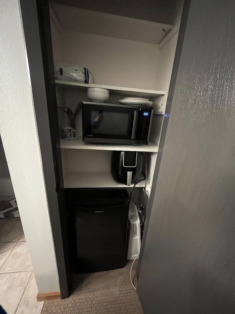 Kitchenette featuring air fryer, fridge/freezer, and microwave.
