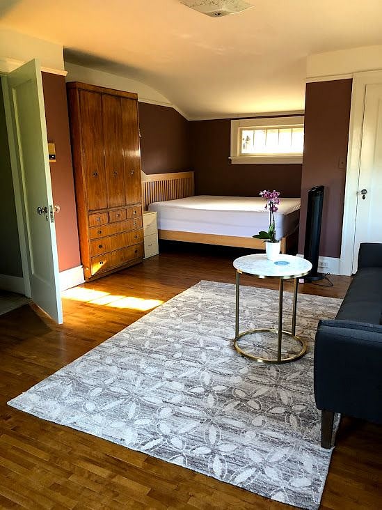 Master bedroom with queen bed has large walk in closet.