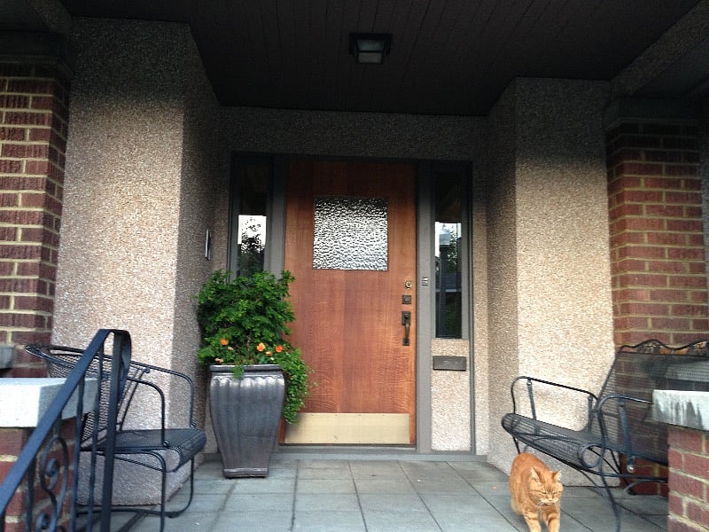 Covered front entry with outdoor seating.