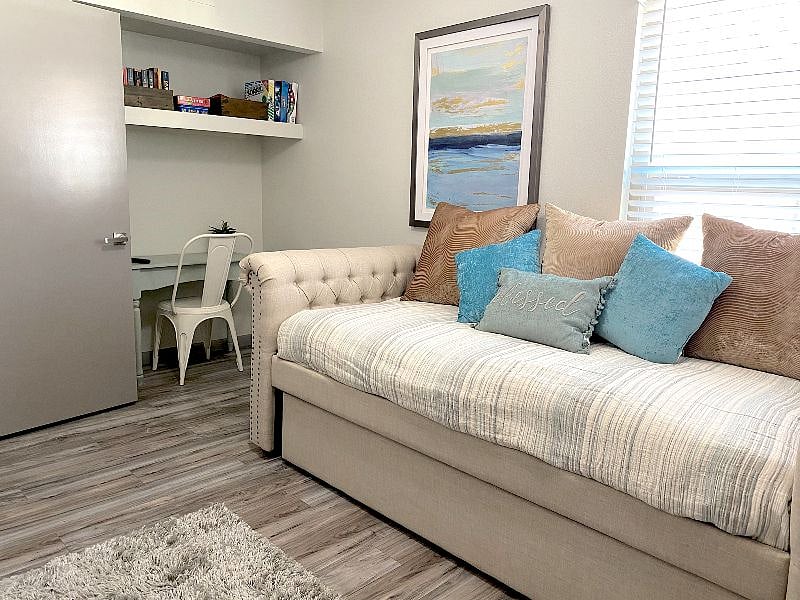 Q1: Bedroom 3: daybed with trundle, 4k Smart TV mounted, double doors lead to living room for accessibility