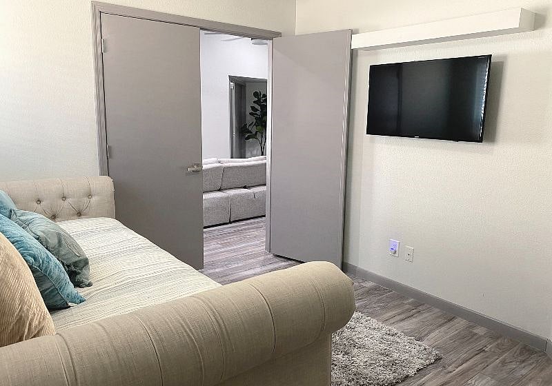 Q1: Bedroom 3: daybed with trundle, 4k Smart TV mounted, double doors lead to living room for accessibility
