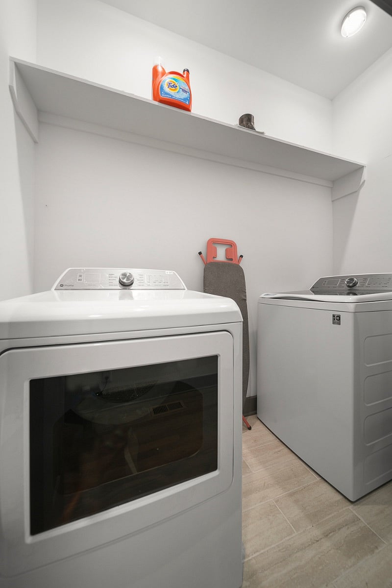 Laundry room with washer and dryer. There is also an iron and ironing board in this room. This laundry room is on the first floor and is shared with the downstairs apartment. This is the only shared space of the unit.