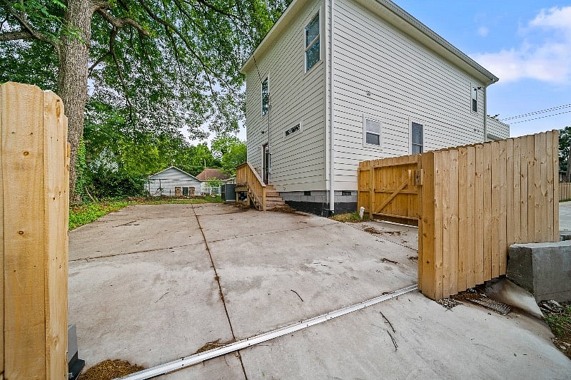 This is the back of the house with the free parking in the back. This whole parking area will be for you to use. The other unit uses the front driveway. The entrance to the upstairs unit is through this back door entrance with a smart lock.