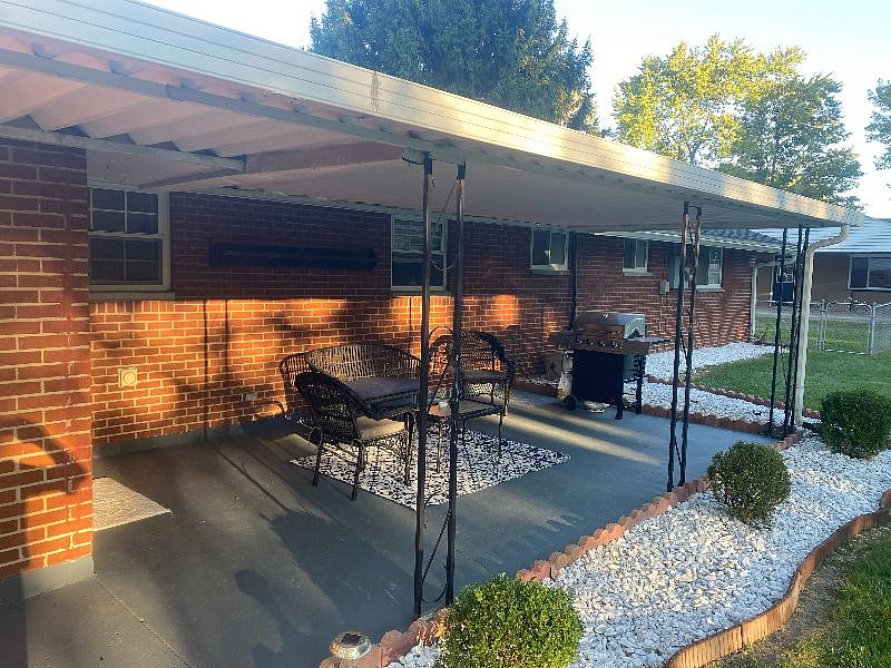 COVERED PATIO FOR YOUR MORNING COFFEE WITH COMFORTABLE PATIO FURNITURE AND PROPANE GRILL FOR YOUR BBQ DINNERS