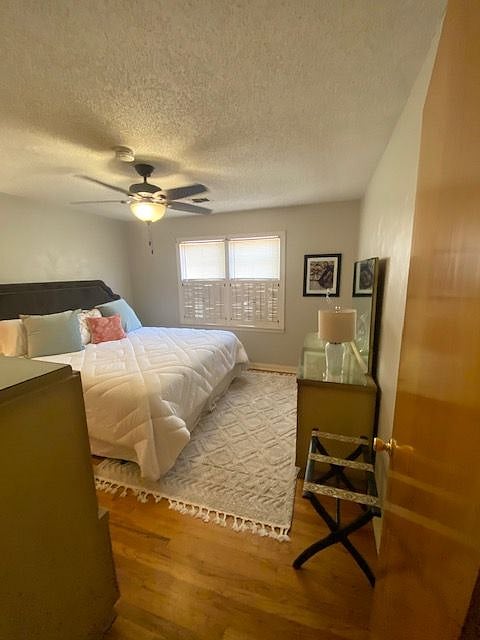 The front bedroom has plenty of storage in the retro mid-century modern dresser, mirror and chest.
