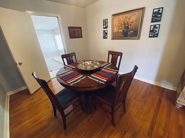 The dining area is open to the living area and furnished with this large oak ball & claw dining table and 4 chairs.