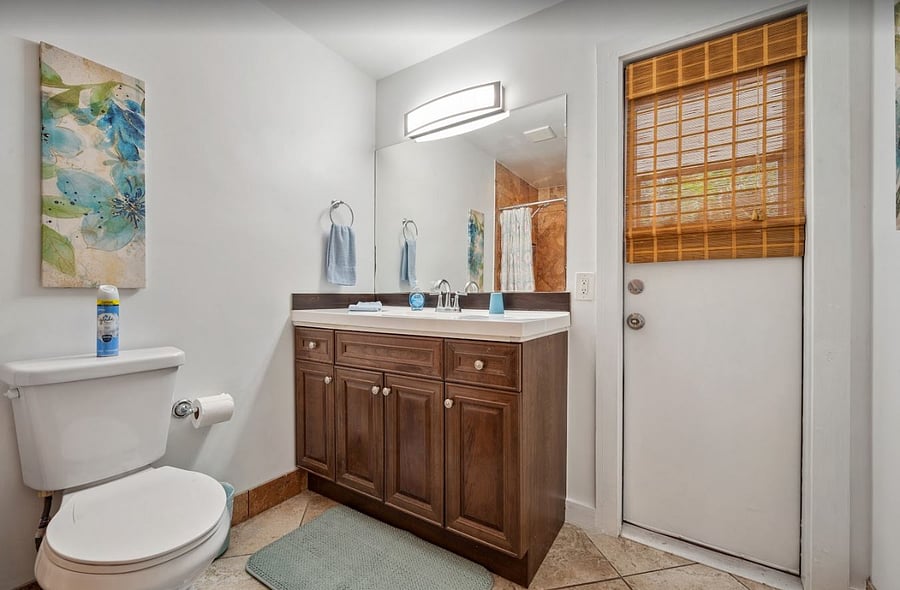 Large guest bathroom b/w 2nd and 3rd bedroom features new vanity, wide custom tiled shower, and side door to private back patio. 