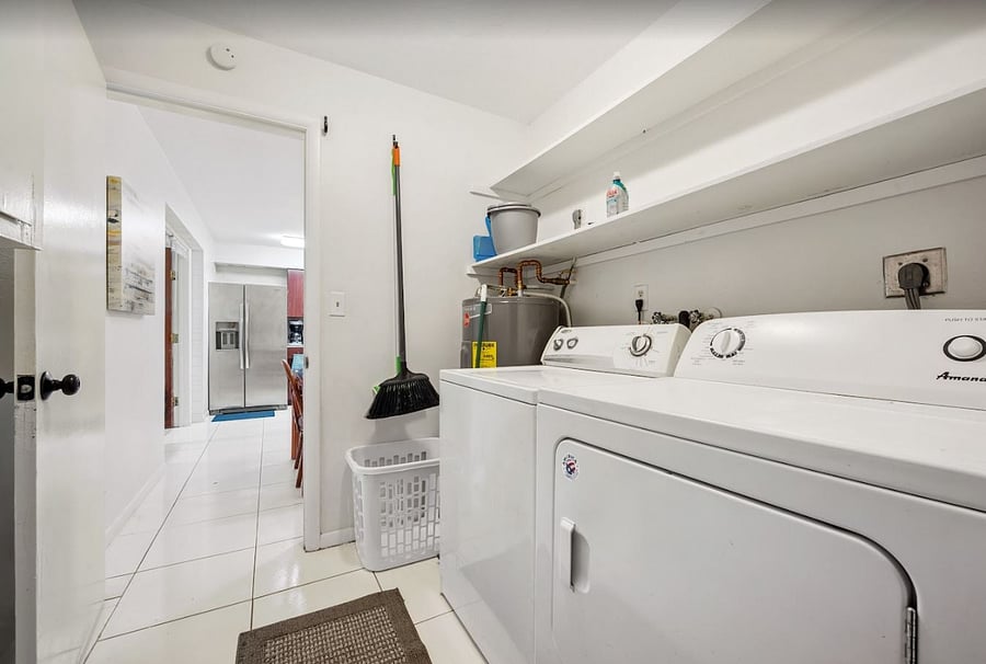 Private Laundry room with extra storage off of kitchen. 