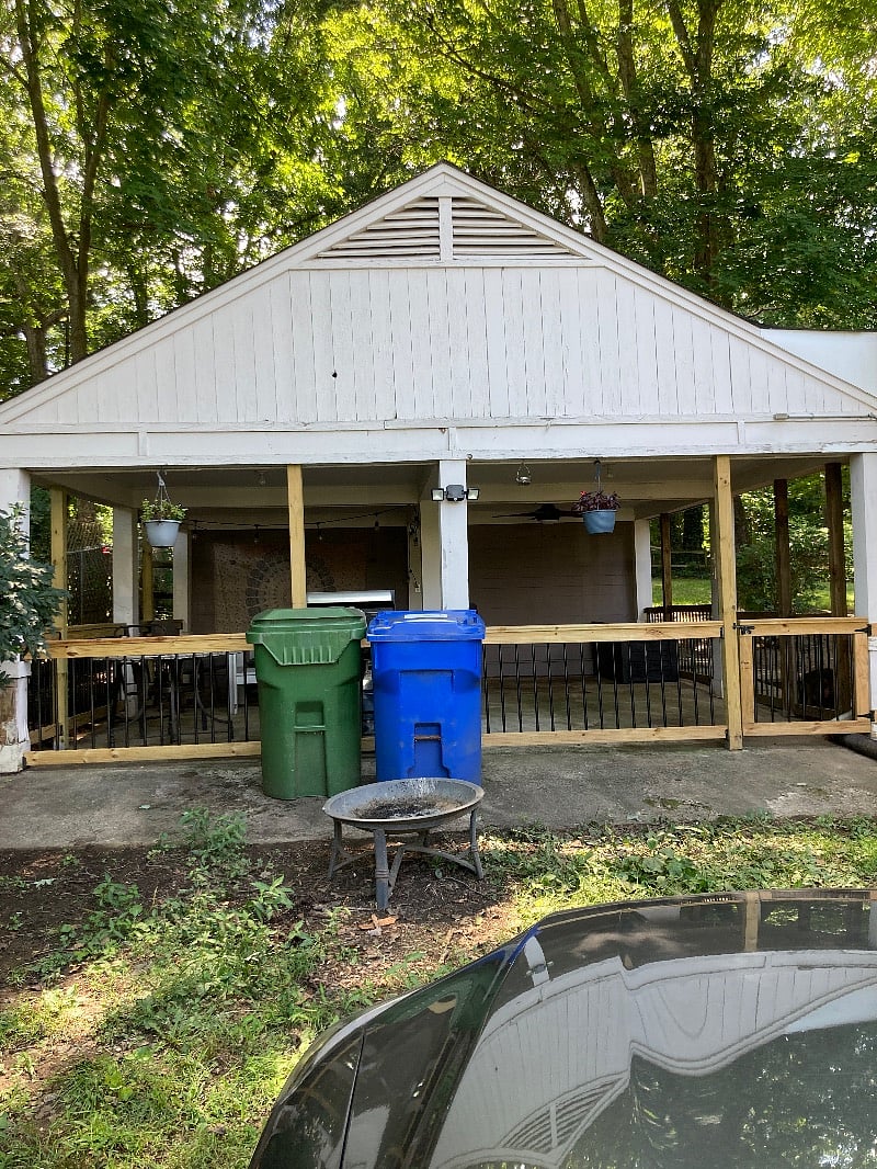 Around the right side of this covered area is the entrance to the shedempty and ready to be used as storage.