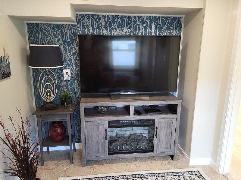 Large 55" TV. Netflix and Cable included. Electric fireplace with a built-in heater for extra warmth.