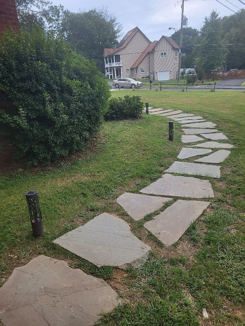 Walkway from courtyard. Lighted pathway for security at night. Use also have your own parking space in driveway. No street parking required!