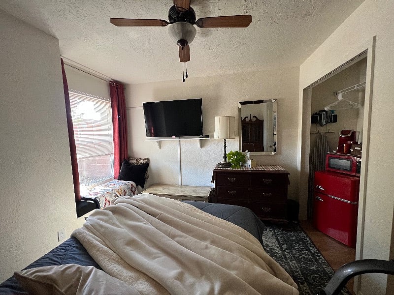 Smart TV, mini refrigerator freezer and keurig coffee maker in room