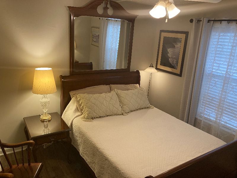 Bedroom 2 features a very cozy queen bed, warm reading lamps, and bountiful storage.