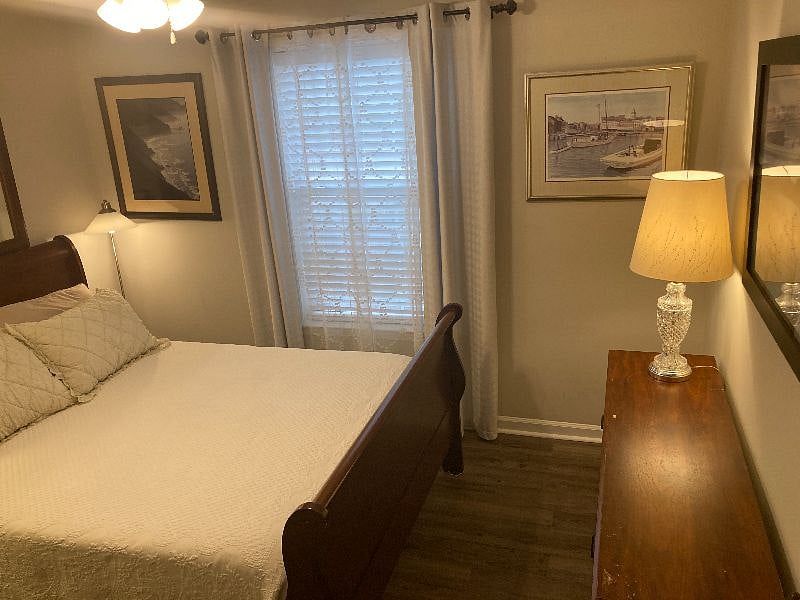 Bedroom 2 features a very cozy queen bed, warm reading lamps, and bountiful storage.