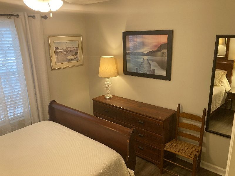 Bedroom 2 features a very cozy queen bed, warm reading lamps, and bountiful storage.