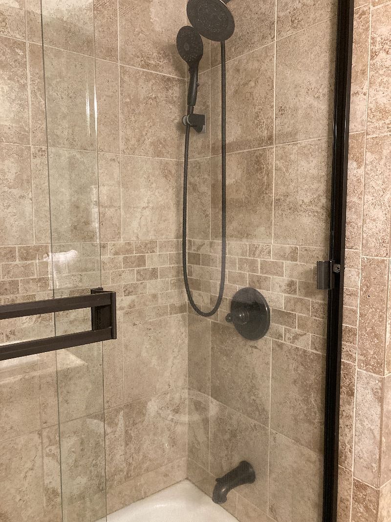 The hall bath features fresh towels, a starter set of soaps, shampoos, a bidet, and a shower / tub combo with fixed and handheld shower heads