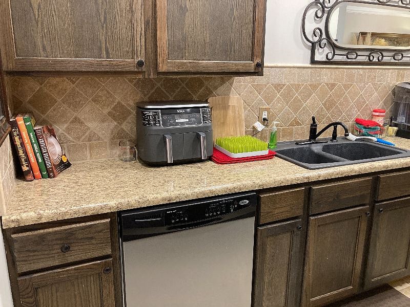 Galley kitchen includes Keurig and drip coffeemakers, an air fryer, toaster oven, blender, tea pot, and microwave.