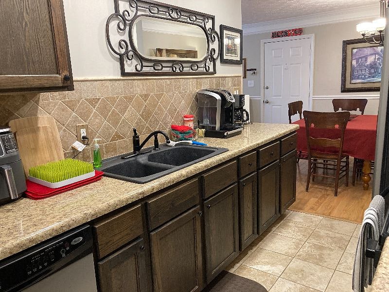 Galley kitchen includes Keurig and drip coffeemakers, an air fryer, toaster oven, blender, tea pot, and microwave.