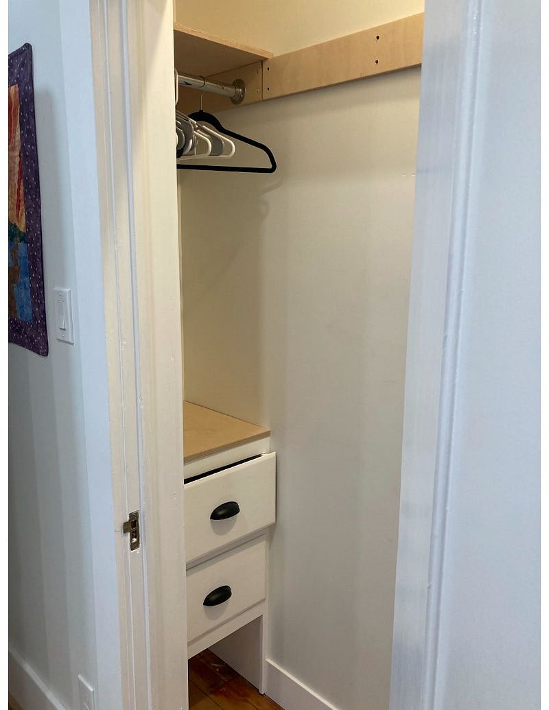 bedroom closet with drawers and storage on both sides