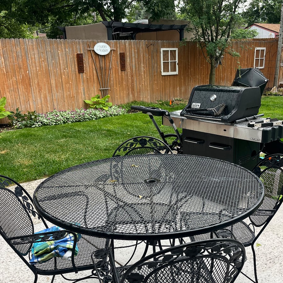 Outdoor dining table with seating for 4 and LP grill. Shared space with landlord