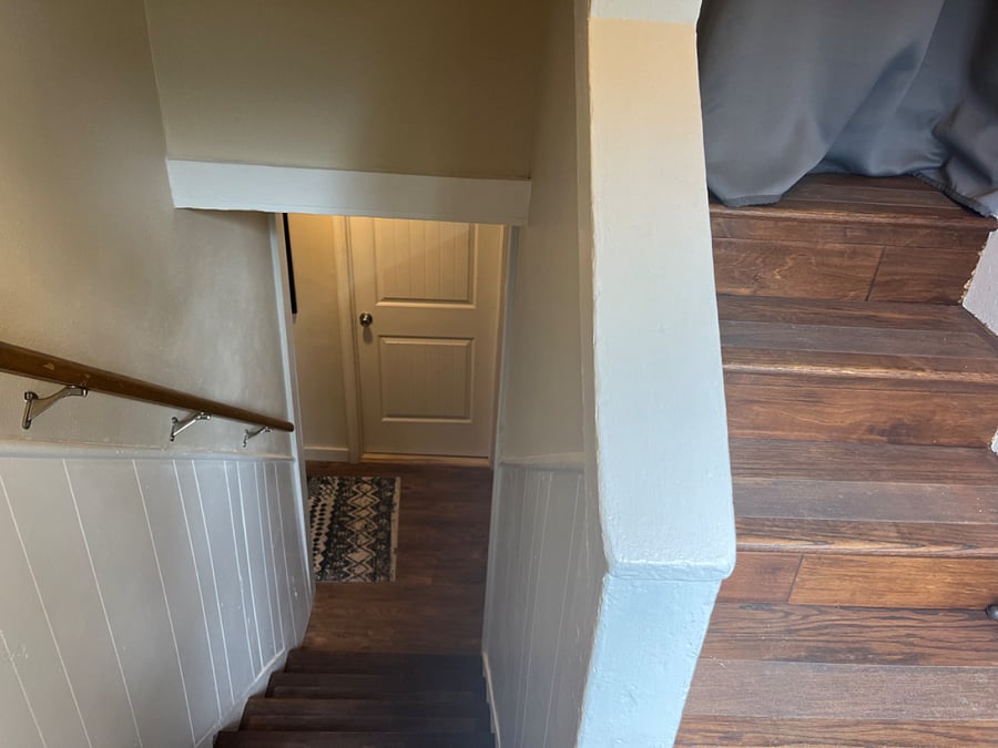 Split stairway. Tenant goes downstairs, landlord goes upstairs.