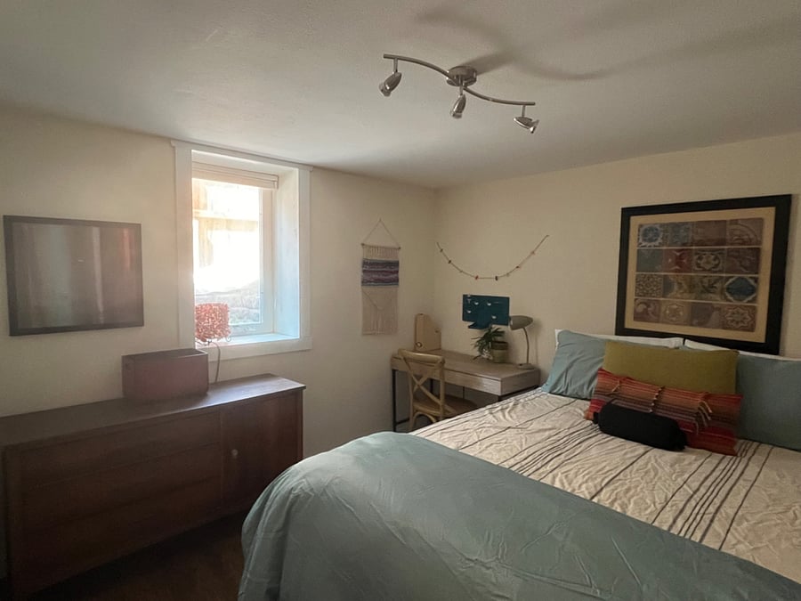 egress window, dresser, desk, queen bed