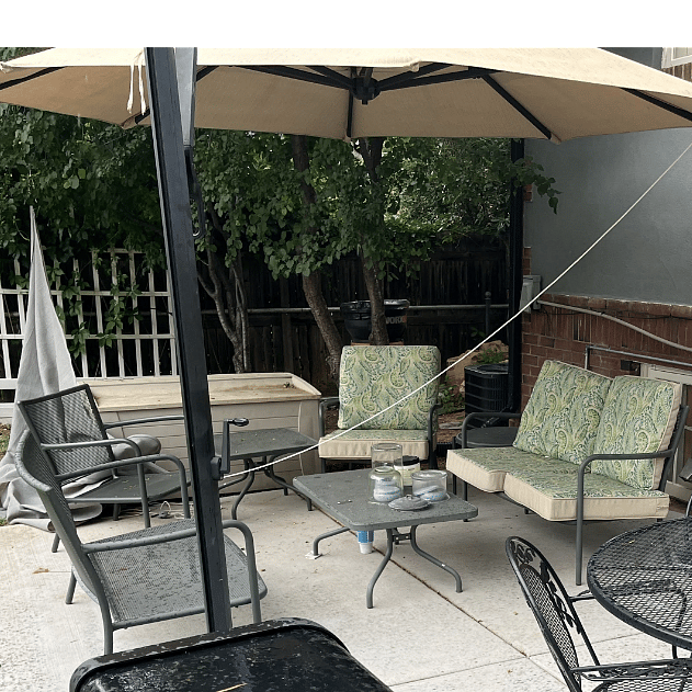 outdoor living with grill, table for four, and lounge area with cantilever sun umbrella