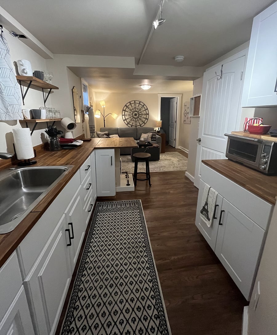 view of living room and bedroom door from kitchenette