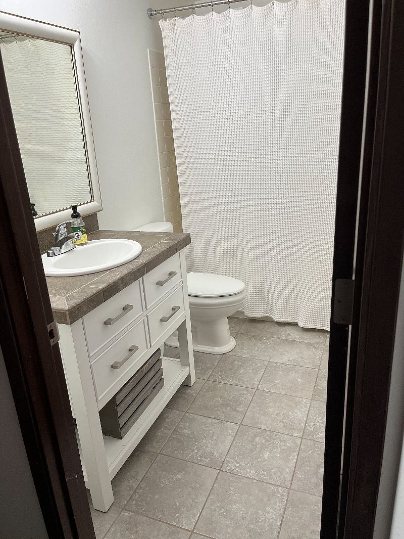 Large vanity with storage under. Bathtub/shower combo
