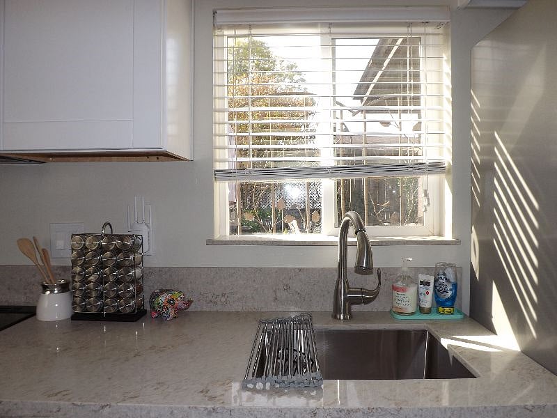 Sunny kitchen with a garden view.