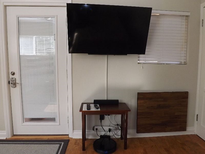 48-inch SONY Smart TV, sound bar, and Eufy robot vacuum cleaner.