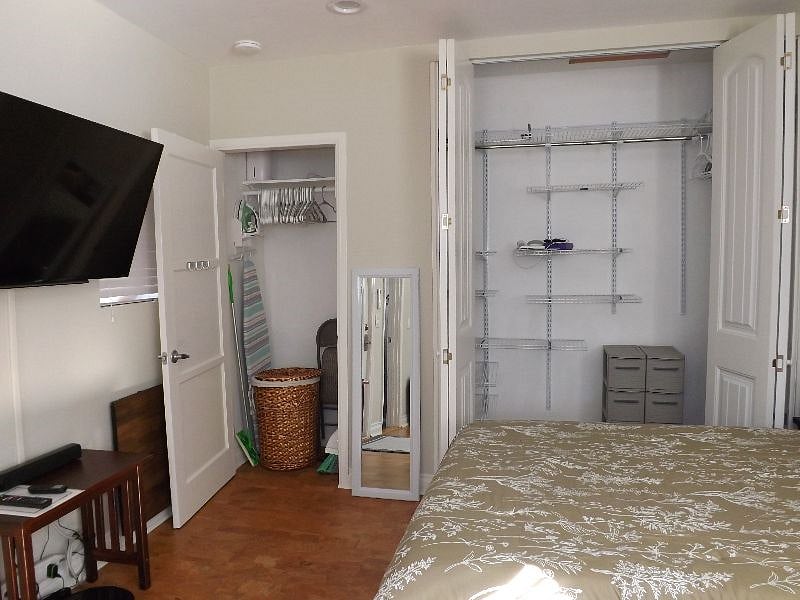 The studio has 2 closets.  The larger one has built-in organizing/rack system with small plastic drawers.  Smaller closet includes a full-sized ironing board, vacuum, broom, hamper, and folding chair.
