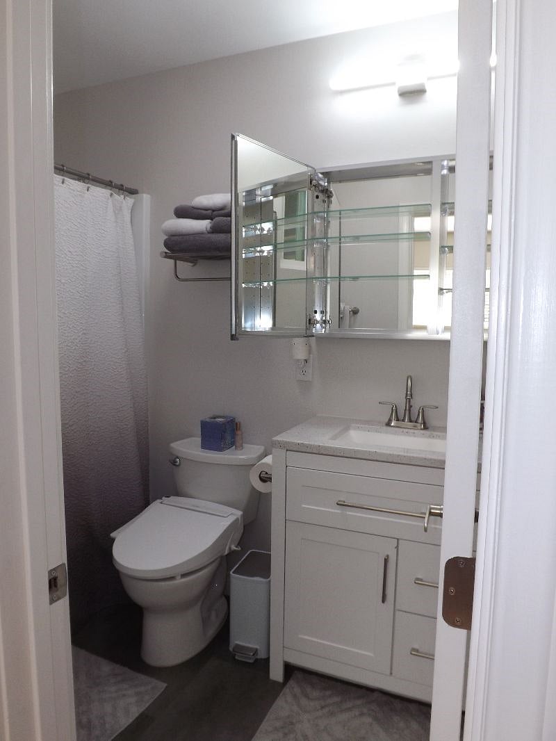 Double-door mirrored medicine cabinet offers more storage.