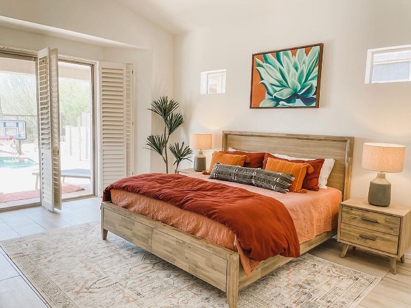 Primary suite features king bed and access to the back yard.