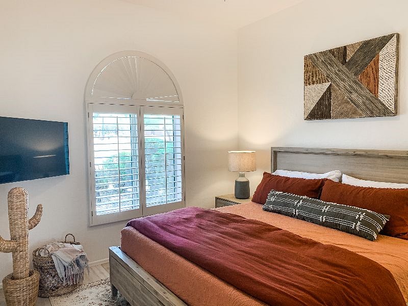 Second bedroom features king bed and smart TV. Full closet with drawers, hang bars and shelves.