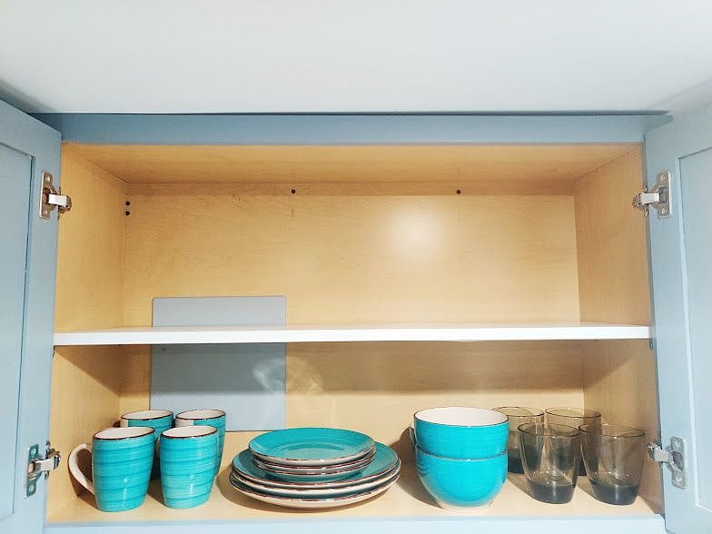 Stylish Dishware. Pots and Pans stored Under Sink