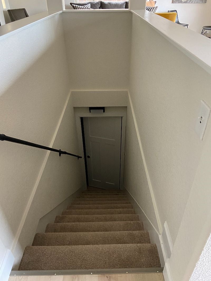 Stairs in Kitchen leading downstairs to laundry room. Laundry room is shared with tenants in basement. The door at the bottom locks.
