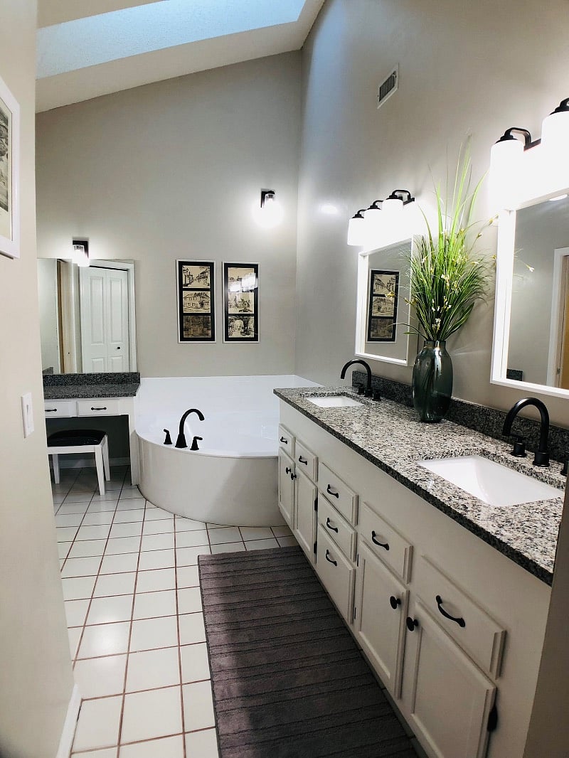 Primary bathroom with double vanity, soaking tub, and ample counter space