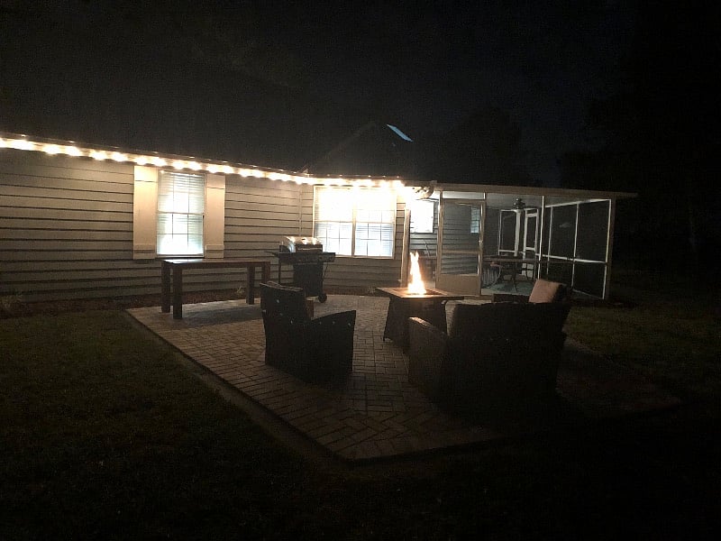 Evening view of private backyard and patio lighting