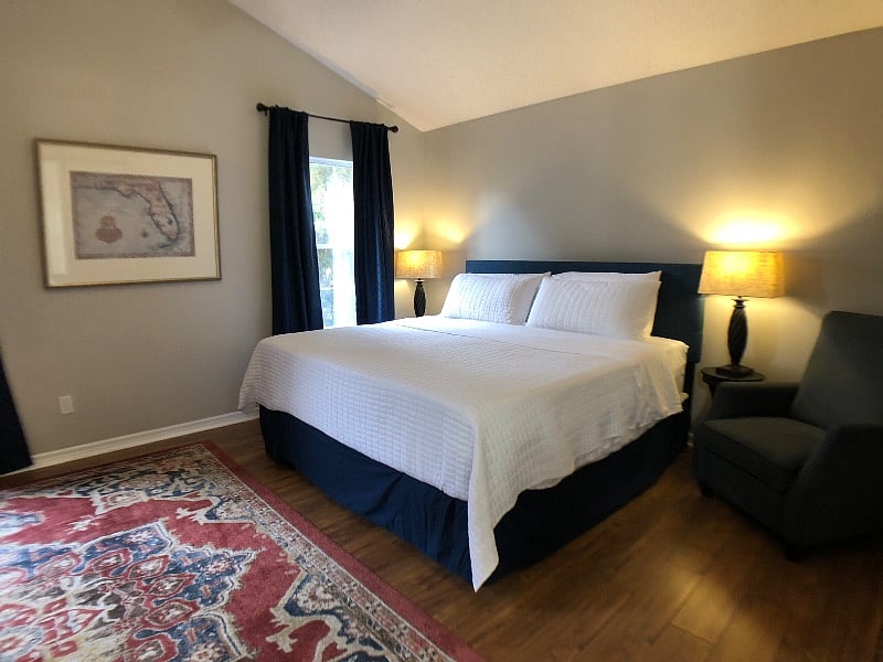 Primary bedroom with king bed, nightstands, and ample natural light