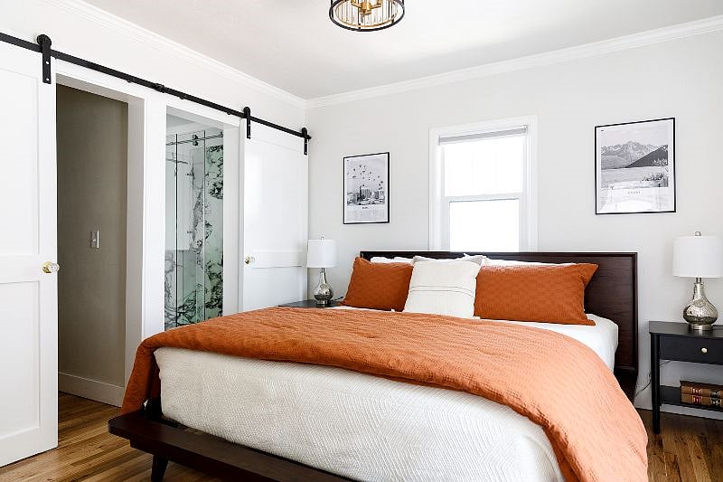 The primary bedroom features a king bed, walk-in closet and private bathroom